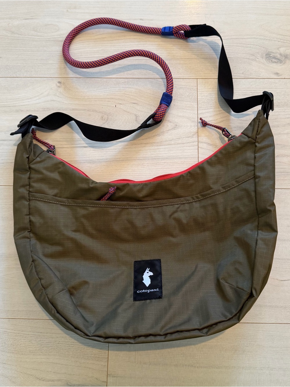 cotopaxi brown messenger bag with red accents Like New